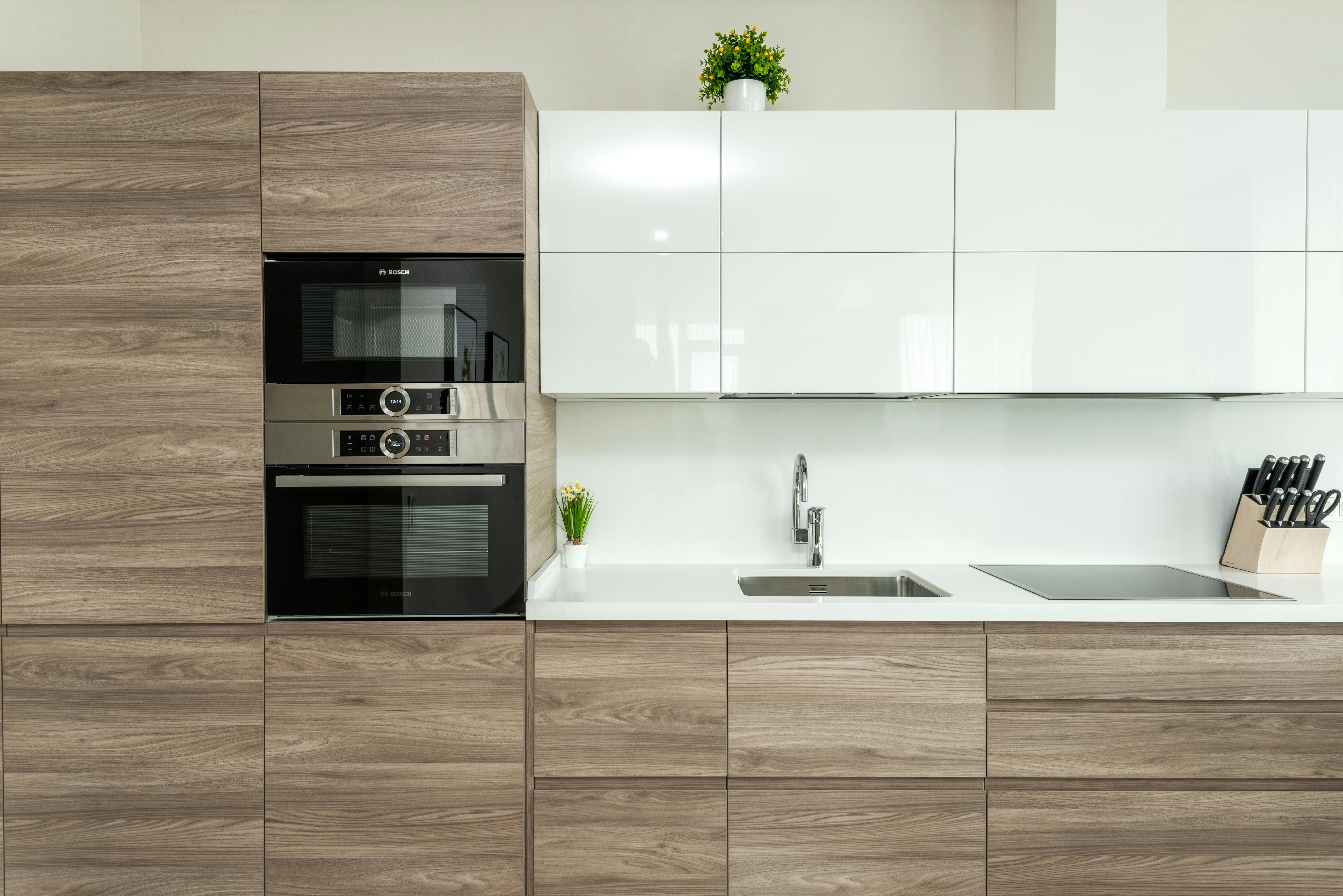 Modern kitchen with wood grain lower cabinets and white gloss upper cabinets
