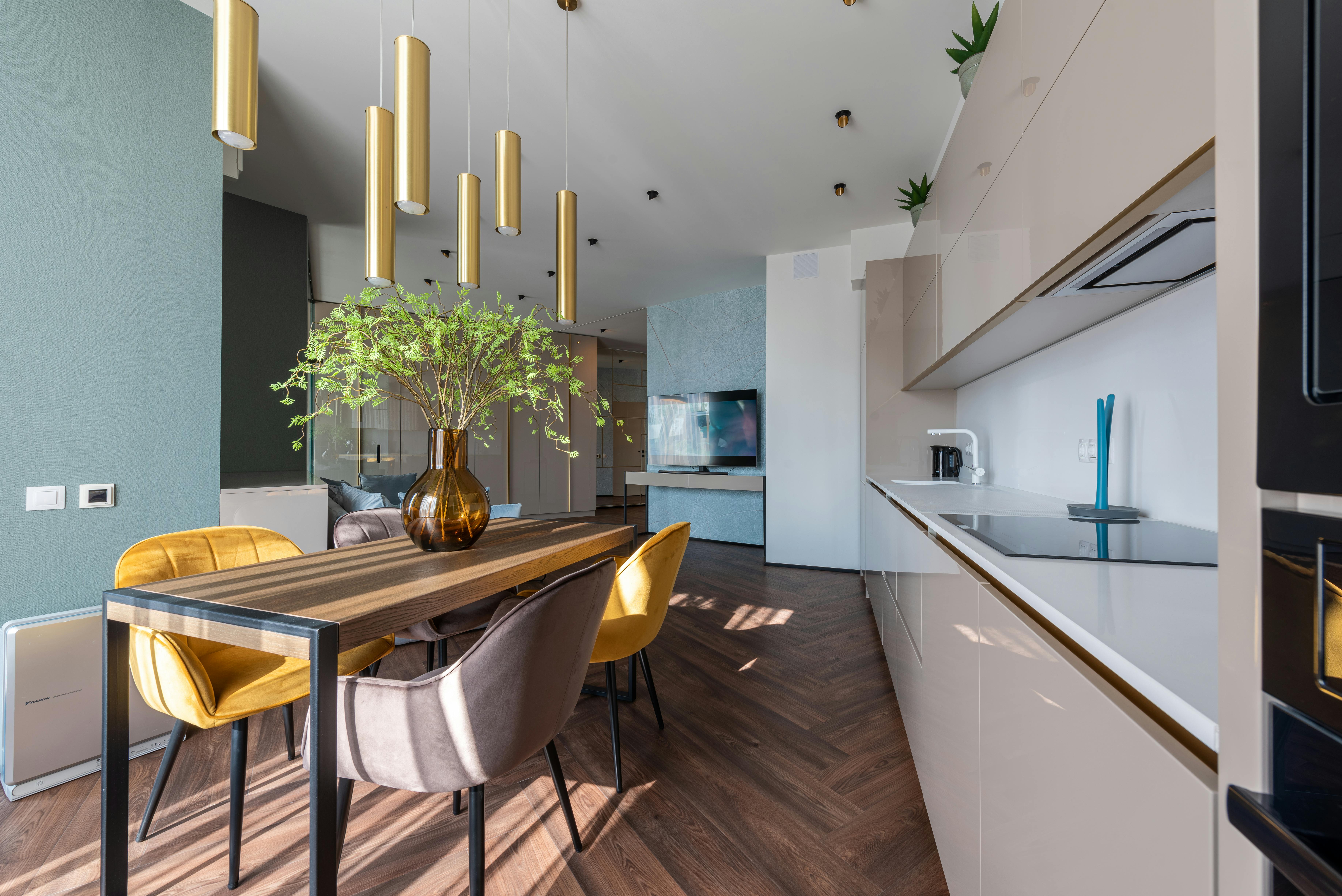 Modern kitchen with white cabinets, stainless steel appliances, and a large island. 